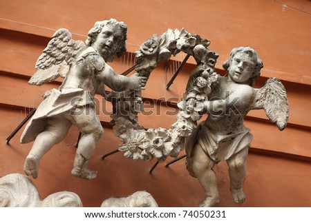 Modena in Emilia-Romagna region of Italy. Angels sculpture outside Saint Barnaba church.