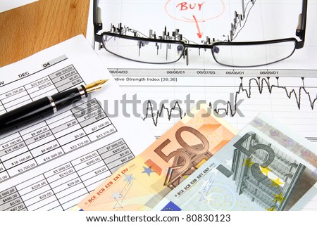 Business composition. Financial analysis - income statement, ink pen and Euro money.