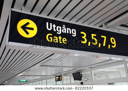 Typical illuminated directions sign in a modern international airport. Malmo Airport terminal - English and Swedish language.