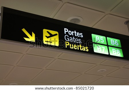 Valencia Airport, Spain - sign to departure gates in Valencian, English and Spanish languages