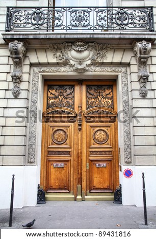 Paris, France - typical old apartment building. Wooden door.