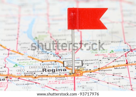 Regina in Saskatchewan, Canada. Red flag pin on an old map showing travel destination.