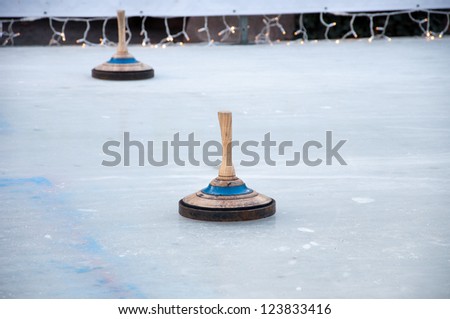 Two bavarian curling stones on an ice rink