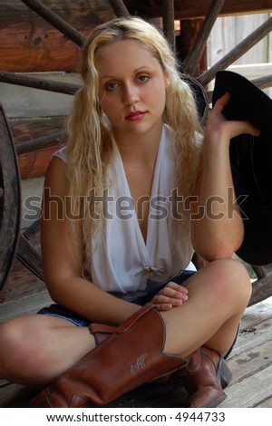 Cowgirl sitting on a rustic porch