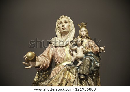 Virgin Mary with child Jesus, detail of antique sculpture, religion