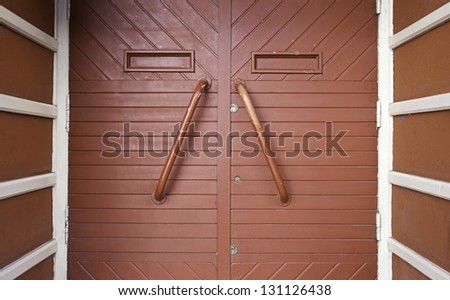 Red wooden door, detail of a closed door in the city, detail of decoration in the city, wooden textured background