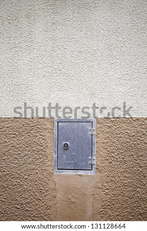 Cement wall with the door closed, detail of the city wall with a metal door, exterior texture background
