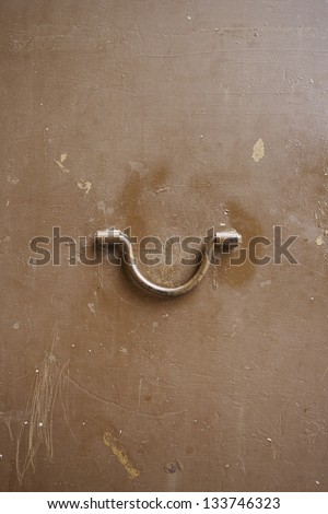 Metal door handle, detail of a metal door in the city, exploration, textured metallic background