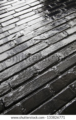 Shiny black floor, black ground detail in the bright city background with texture and shine