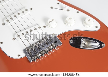 Red electric guitar, string instrument detail, rock music. detail of instrument, musician