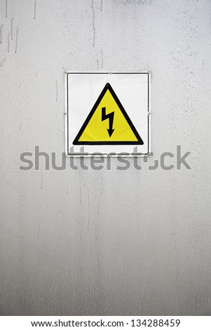 Electrical warning sign, detail of a caution sign on a metal wall, inromation message