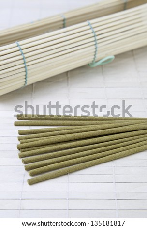 Incense sticks and bamboo detail of aroma therapy on relaxation center, textured background