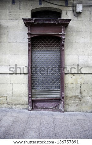 Ancient door in the city, detail of old door store in town, abandoned wall
