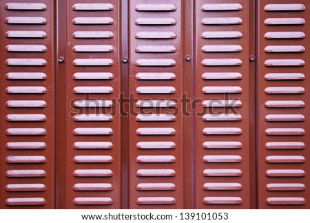 Red metal wall, detail of a red metal wall grille, textured background