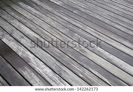 Old wet wood, detail of a wood siding in the city, pedestrian walkway