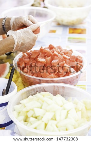 Chunks of watermelon and melon, detail of a person cutting in summer fruit, healthy food, soda
