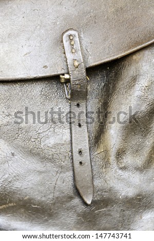 Leather buckle bag, detail of a cowhide bag, old and dirty