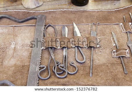 Old tools for leather, detail of a rusty metal tools to work leather