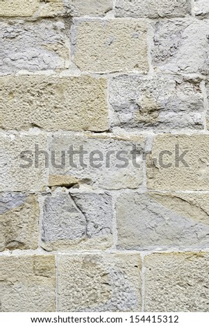 Old stone wall texture, detail of an old stone facade detail and relief