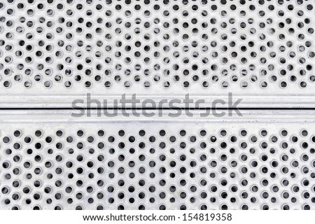 Metal plate with holes, detail of a steel plate, strength and hardness, iron