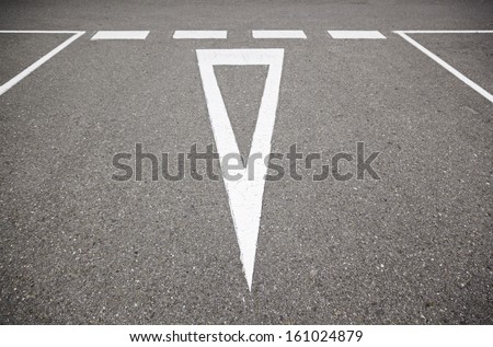 Give Way sign on the asphalt, detail of an information signal in a road, safety and respect