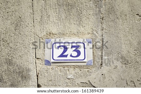 Number twenty on a wall, detail of a number of information in a house in the city