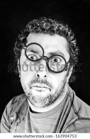 Adult man with crooked glasses, detail of a person with curly hair, fun and surprise