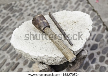 Chisel and hammer stone working, detail of ancient craft with stone carving and shaping the stone