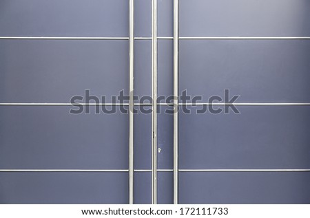 Modern metal door, detail of a door in a modern building architecture and protection