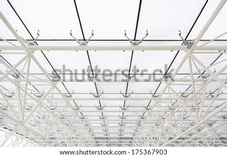Glass roof with white beams, detail of a roof with sky views, safety and security
