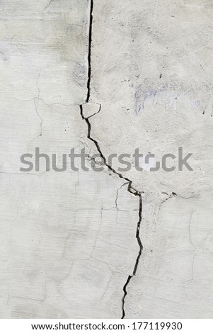Cracked cement wall, detail of a wall damaged by the passage of time, outside facade