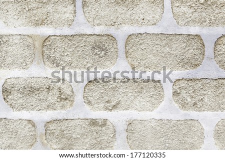 Cement wall with forms, details of a concrete wall decorated with bricks and shapes