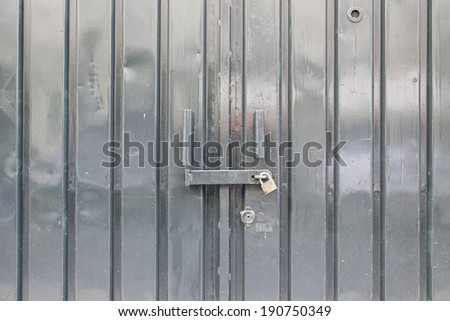 Bright green metal door, detail of a closed door, protection and security