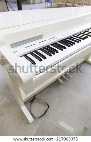 White piano on stage, detail musial instrument of classical music