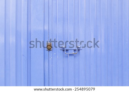 Blue metal door, detail of a closed door painted blue