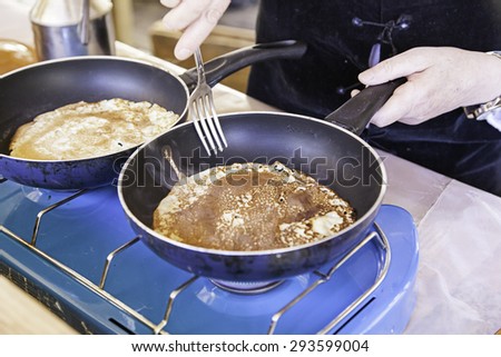 Cooking pancakes on a fair, detail of a position in a market, healthy food, party