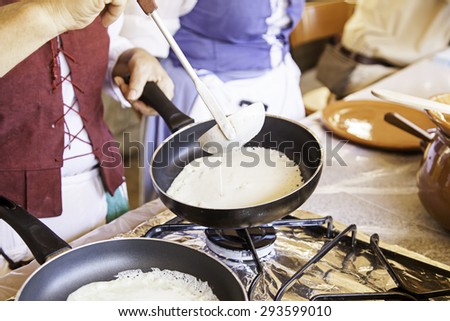 Cooking pancakes on a fair, detail of a position in a market, healthy food, party