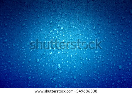 Water drops on blue, detail of a wet blue surface water, rain in the city