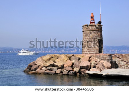 Stone lighthouse at the port of Theoule sur Mer in southeastern France on the french riviera, department Alpes Maritimes