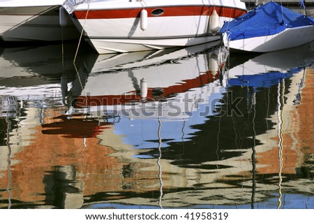 Reflection of hull boat in blue water