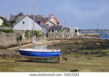 Boat at low tide in the port of Port Louis in the Morbihan department in Brittany in north-western France
