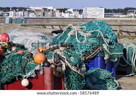 Closeup of fishing nets in large boxes in the port of Quiberon in France