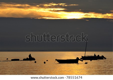 Sunset on the Atlantic ocean with boats at Portivy in Brittany
