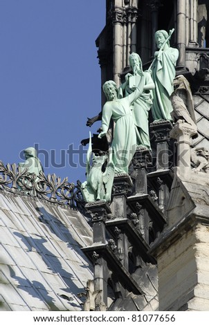 statues of the apostles of Saint Luke at the base of the spire of the cathedral Notre Dame in Paris