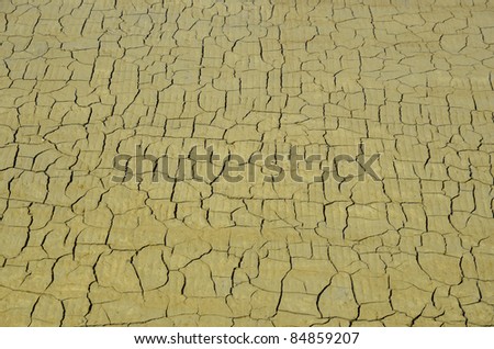 Background cracked ground of salt pan at Guérande in Pays de la Loire region in western France