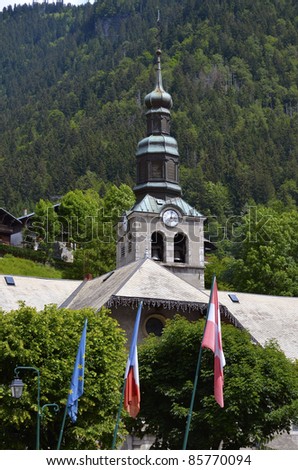 Bell tower of church of Morzine in the mountains of Alps in eastern France, commune in the Haute-Savoie department in the Rhône-Alpes region