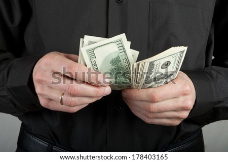 man counts money in hands dollar usa