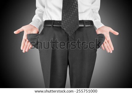 finance concept - bankrupt business man showing empty pockets  hands
