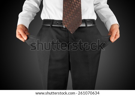 bankrupt business man showing empty pockets  hands