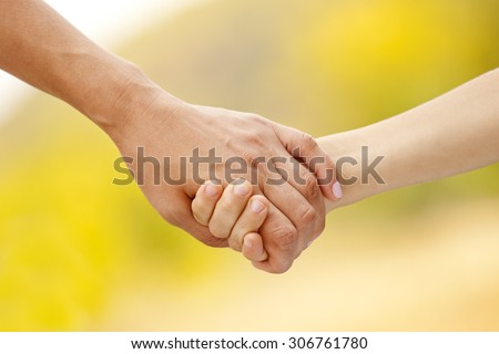 Mother holding the hand of her child. Family love concept